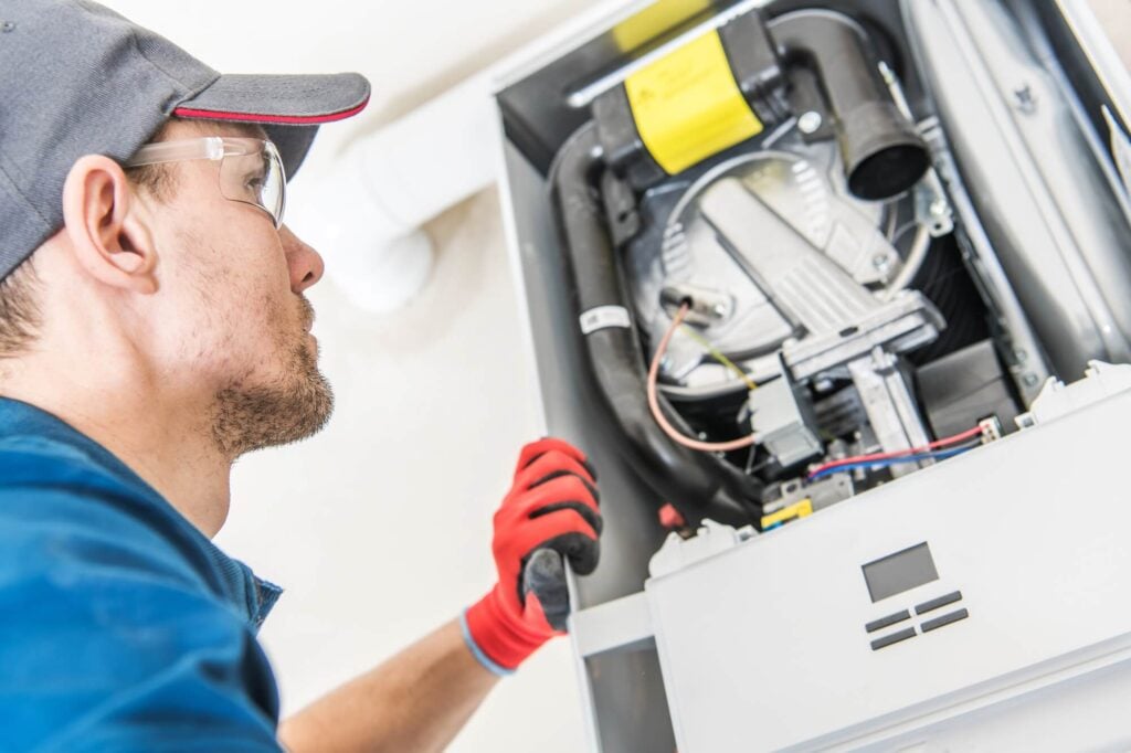 Man looking at furnace before Furnace Repair in Seattle