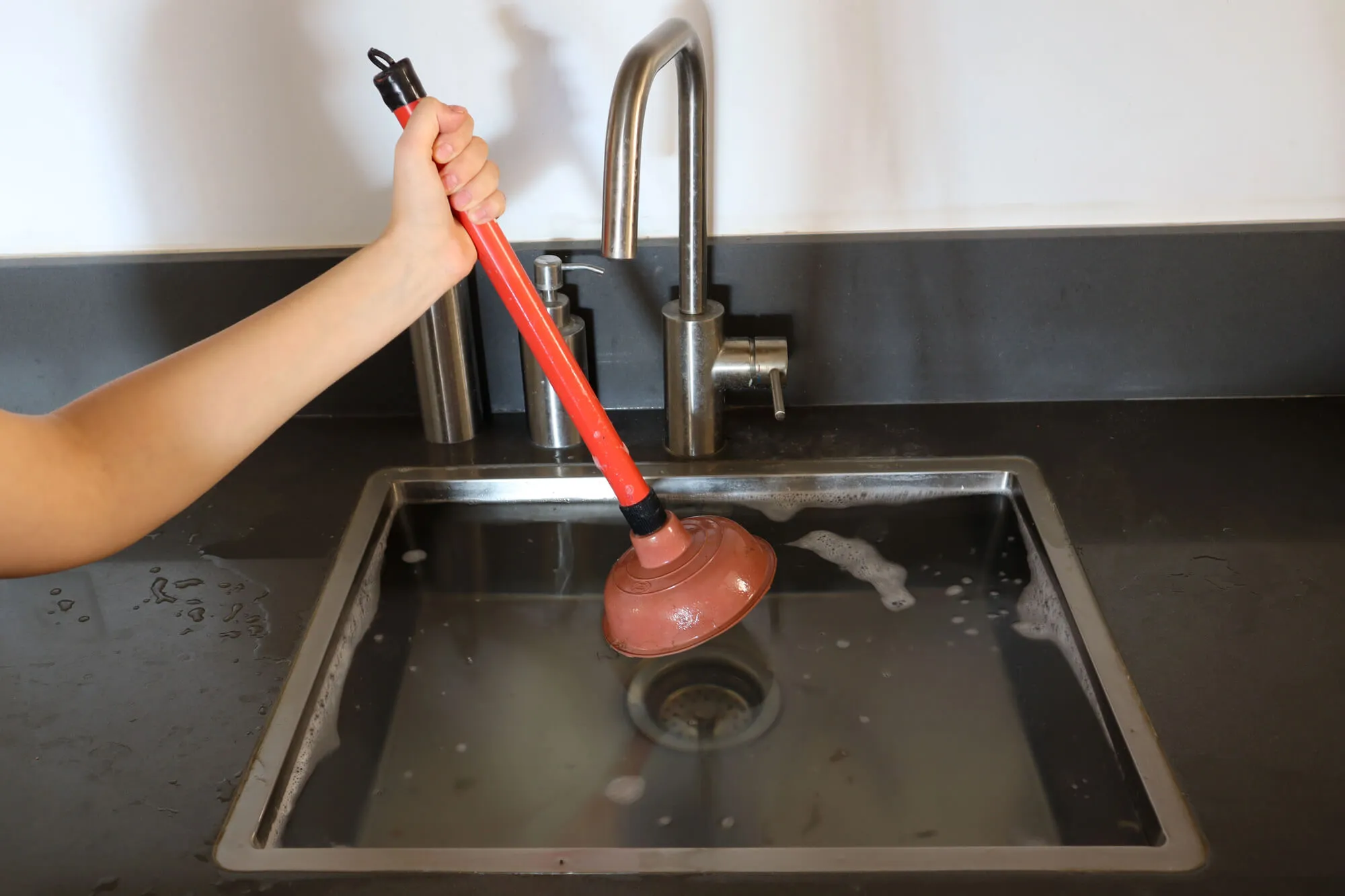 plumber trying to Fix clogged drain Seattle